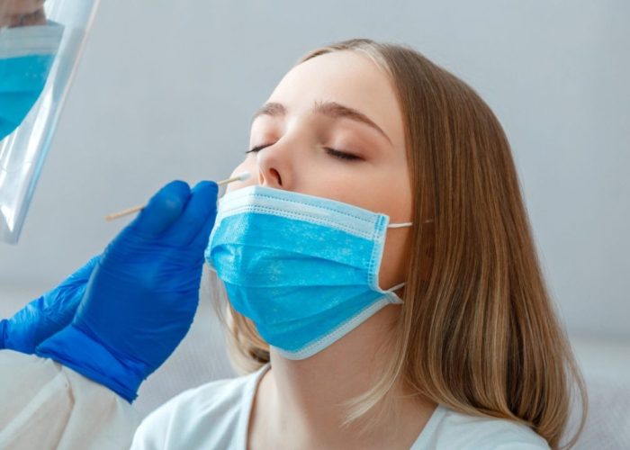 doctor-taking-nasopharyngeal-culture-pcr-test-to-woman-patient-nurse-take-saliva-sample-through-nose-with-cotton-swab-to-check-coronavirus-covid-19-long-web-banner-scaled-1-1280x720