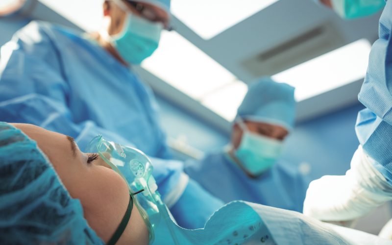 Team of surgeons performing operation in operation theater at hospital