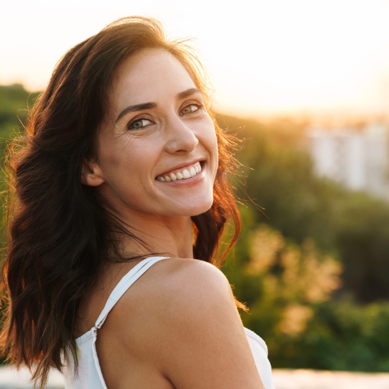 portrait-beautiful-woman-with-long-hair-smiling-while-walking-outdoors